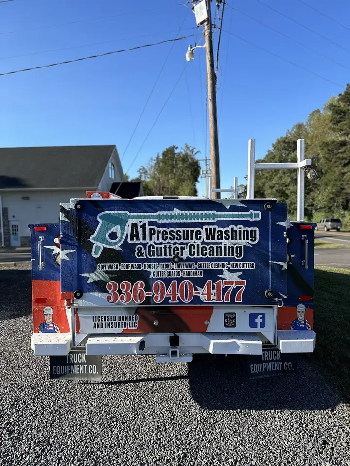 The back of the A1 service body, lettered with the service list, the phone number and licensed bonded and insured
